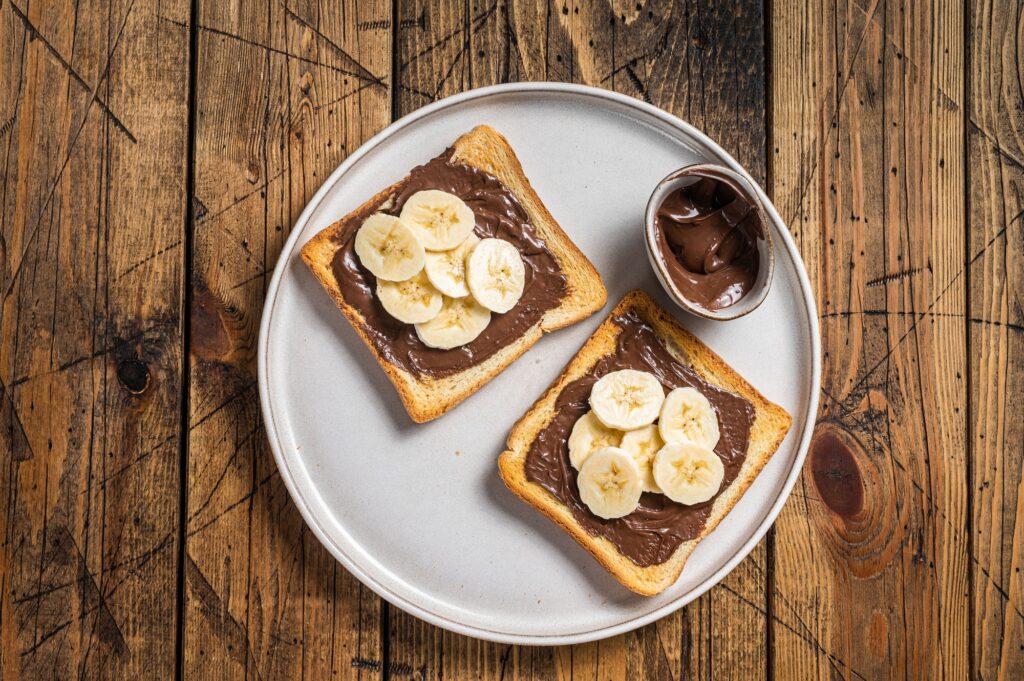 Cooking of sandwich with chocolate Hazelnut butter and bananas.